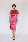 A women is wearing a pink silk Chinese Wedding Cheongsam 