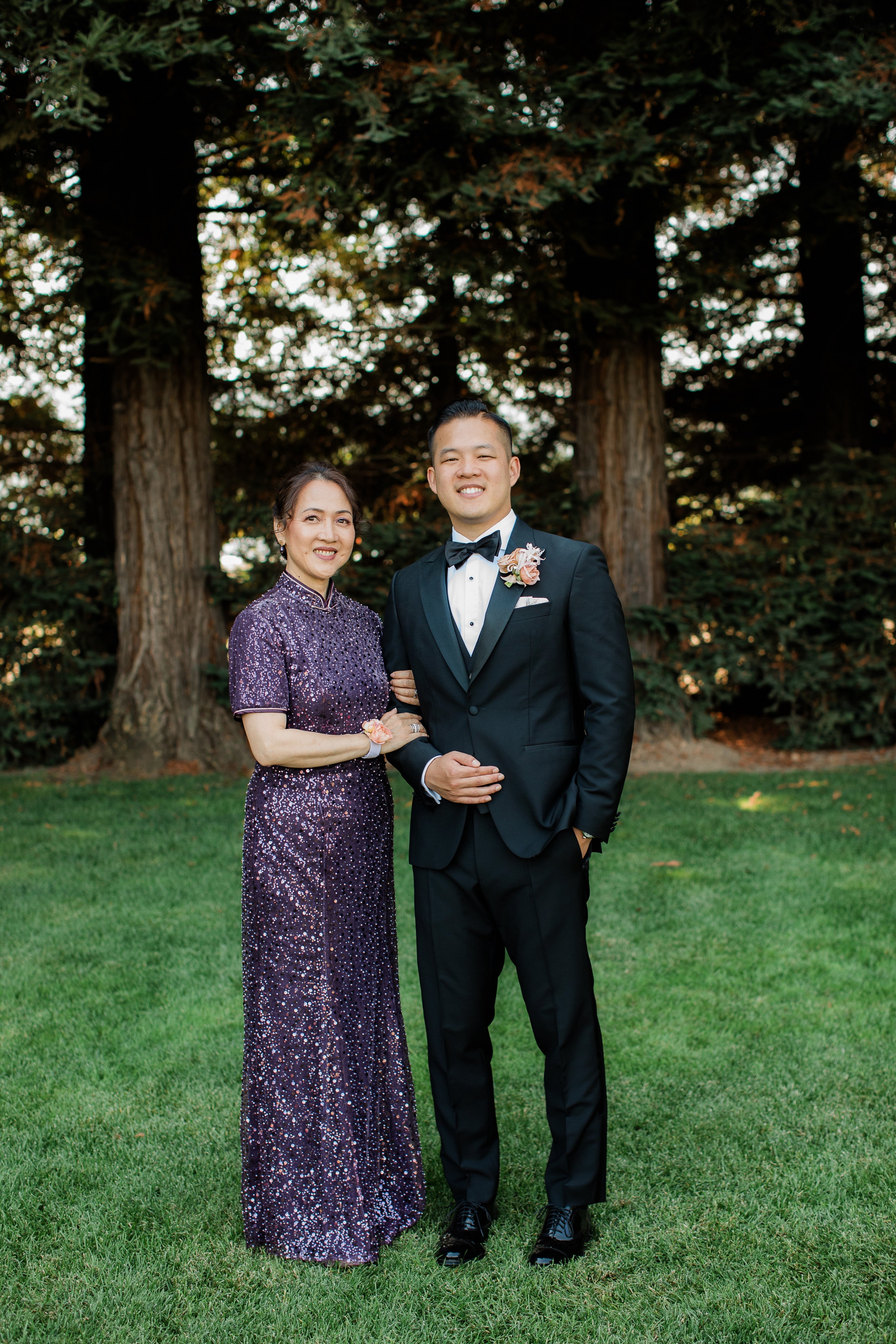 A mother wearing a beaded silk long Cheongsam at her son's wedding