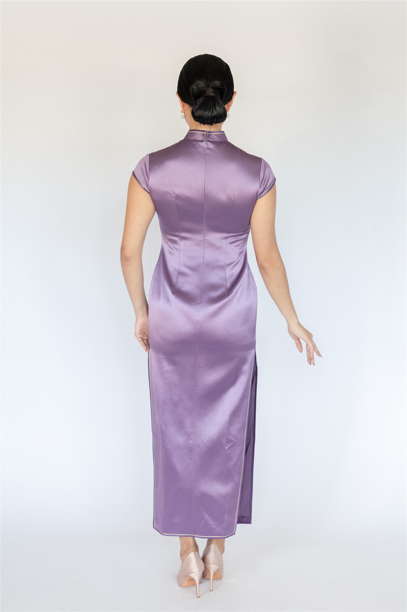 Back view of purple cheongsam showing full silhouette and gold edging