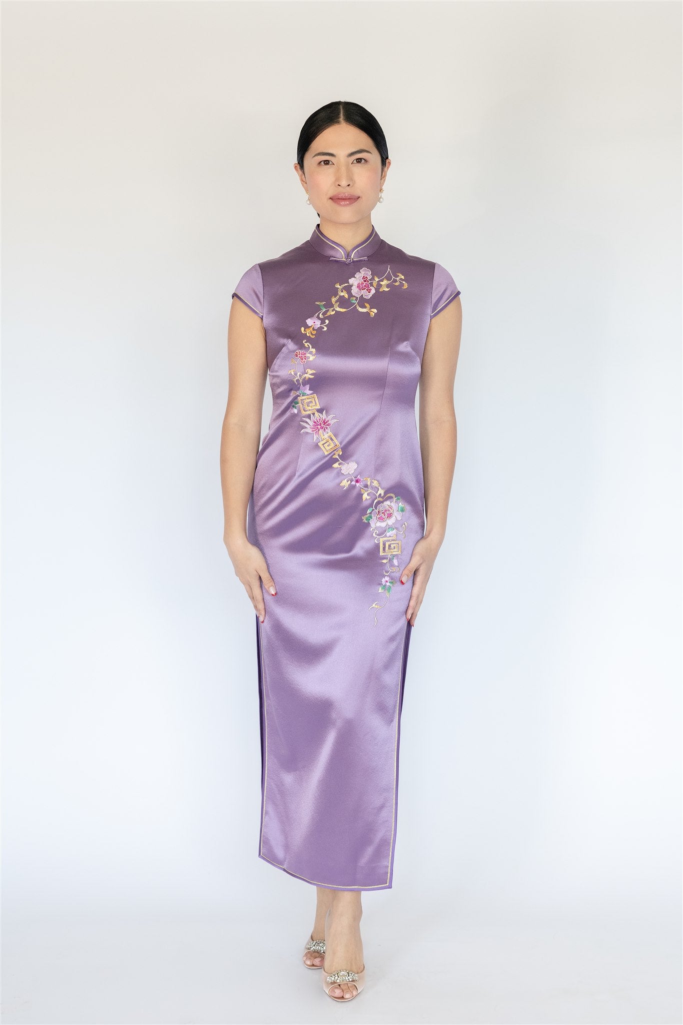 Purple silk Cheongsam with gold trim and auspicious motifs, front view.