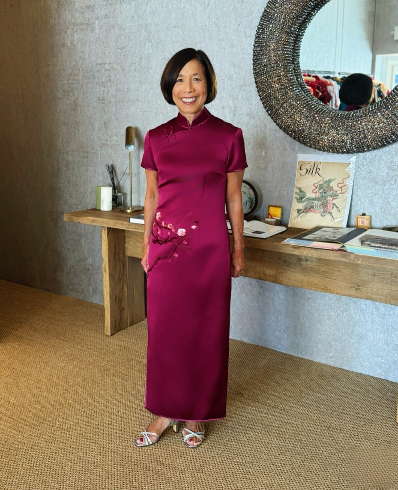 Real client Kris wearing a custom maroon red Qipao with delicate cherry blossom embroidery, blending modern elegance with traditional Chinese dress design.