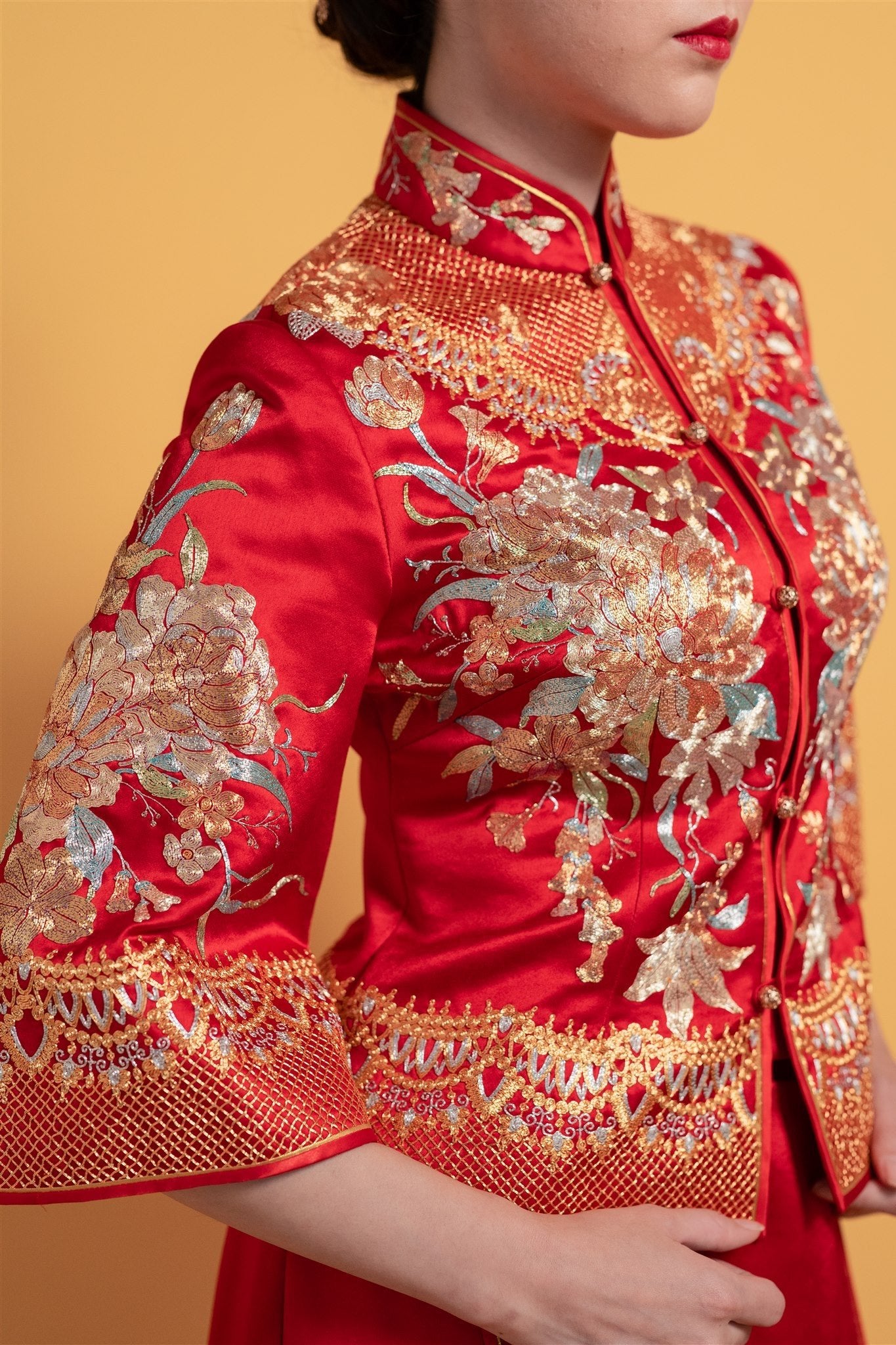 close-up of the peony embroidery on the chest and sleeves of the red xiu he fu.