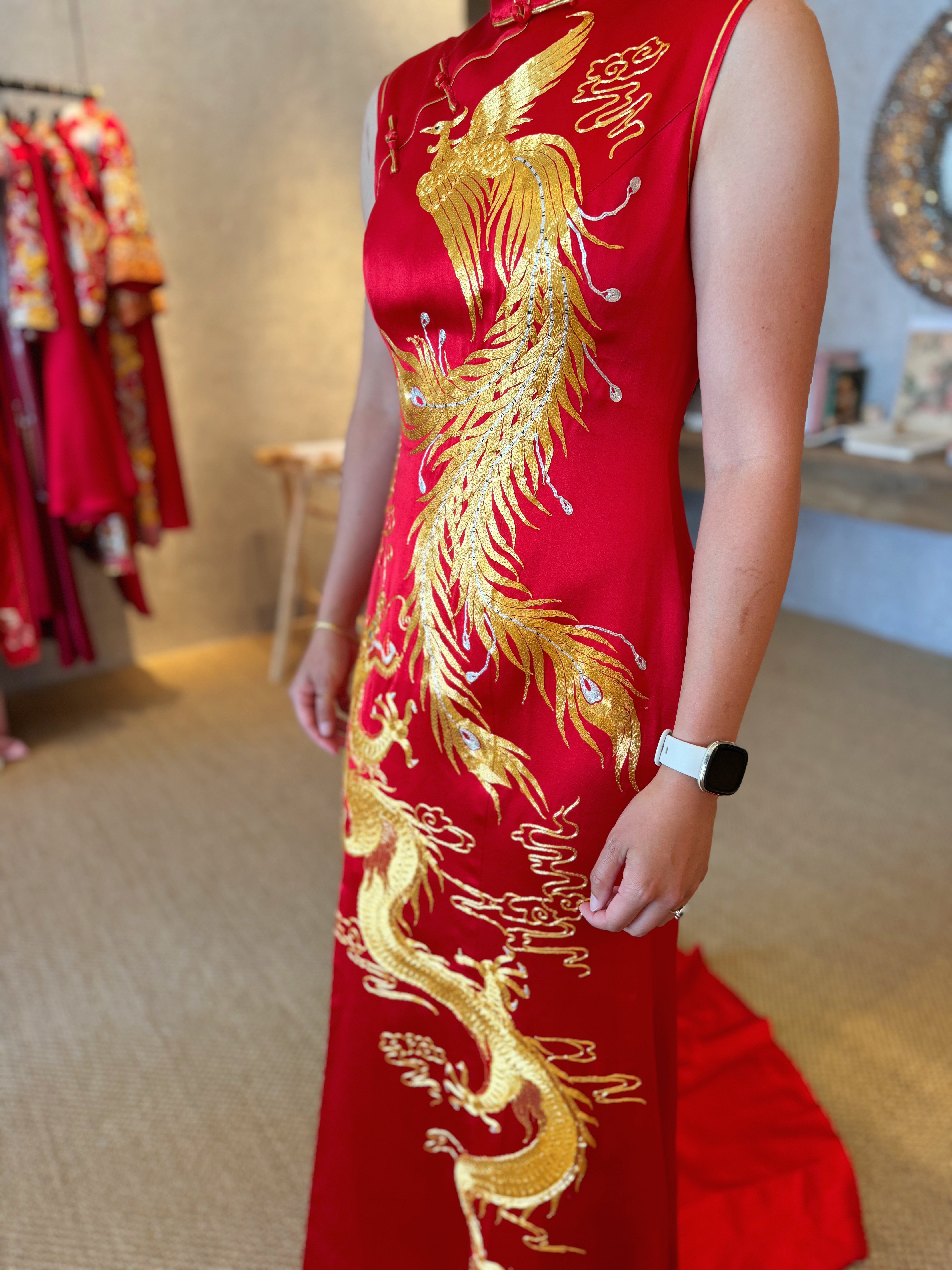 A client wearing her red modern Chinese wedding dress with phoenix and dragon embroidery