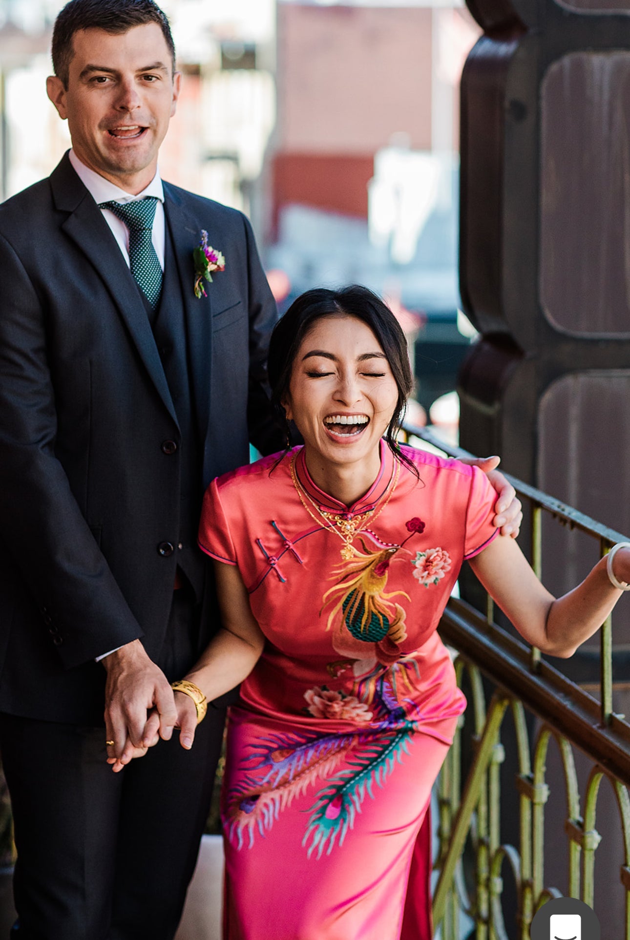 A woman is wearing a red Qipao with phoenix flying through peonies embroidery