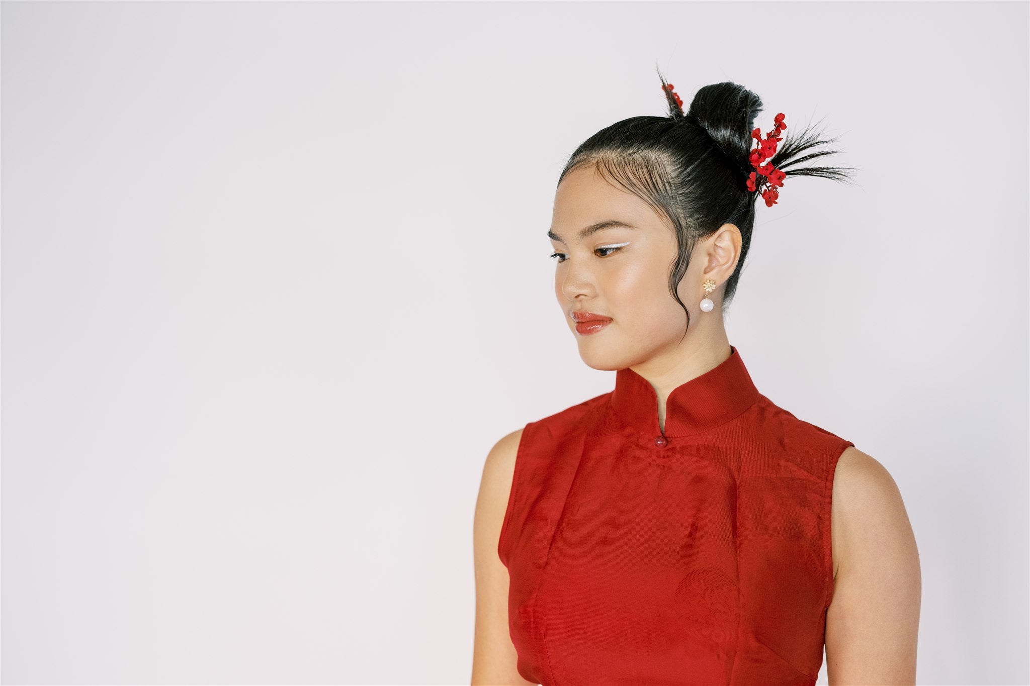 A girl wearing a red silk organza Cheongsam with mandarin collar