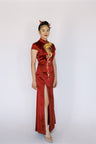 A woman wearing a wine red Mermaid wedding Qipao with hand embroidered phoenix