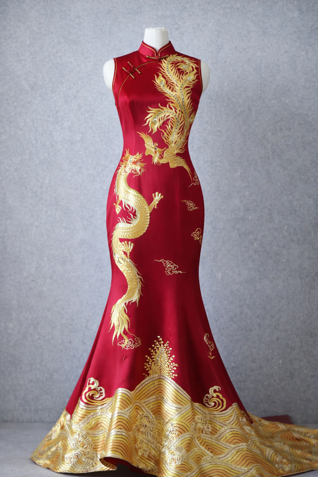 Red silk mermaid Qipao Chinese wedding dress with hand-embroidered dragon and phoenix motifs.