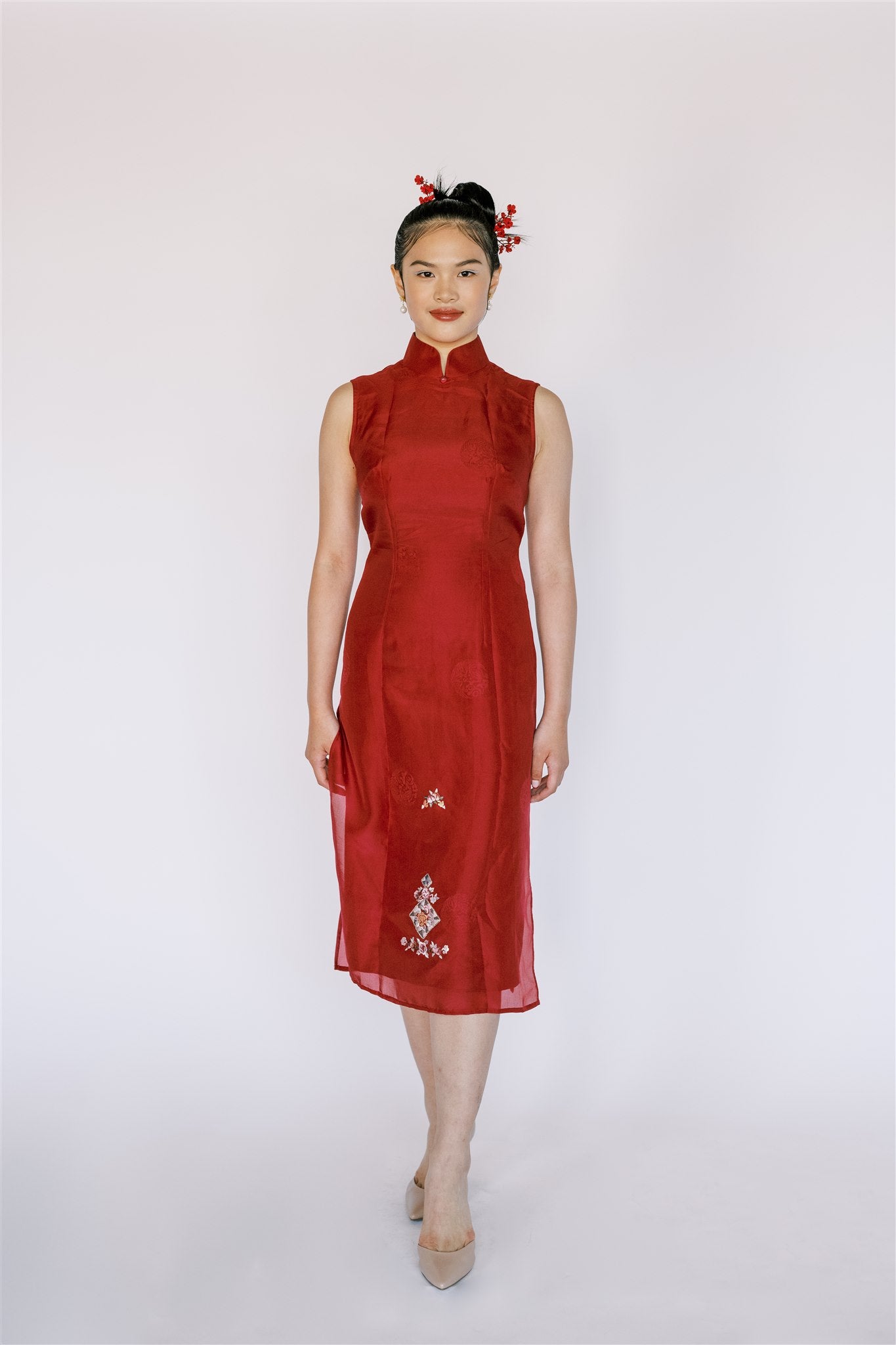 A woman wearing red silk organza Qipao