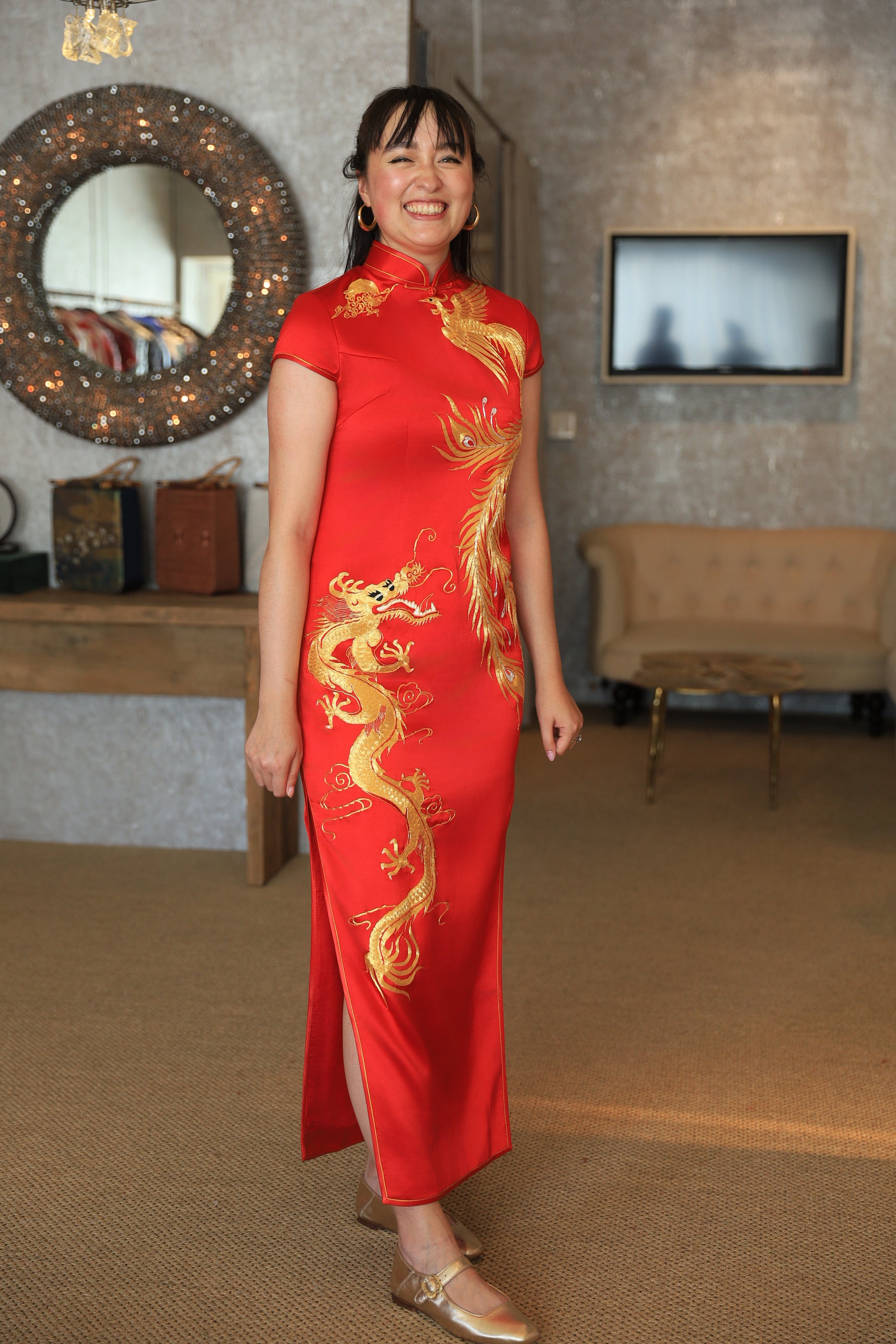 A client wearing her red custom wedding Qipao with moon, phoenix and dragon embroidery