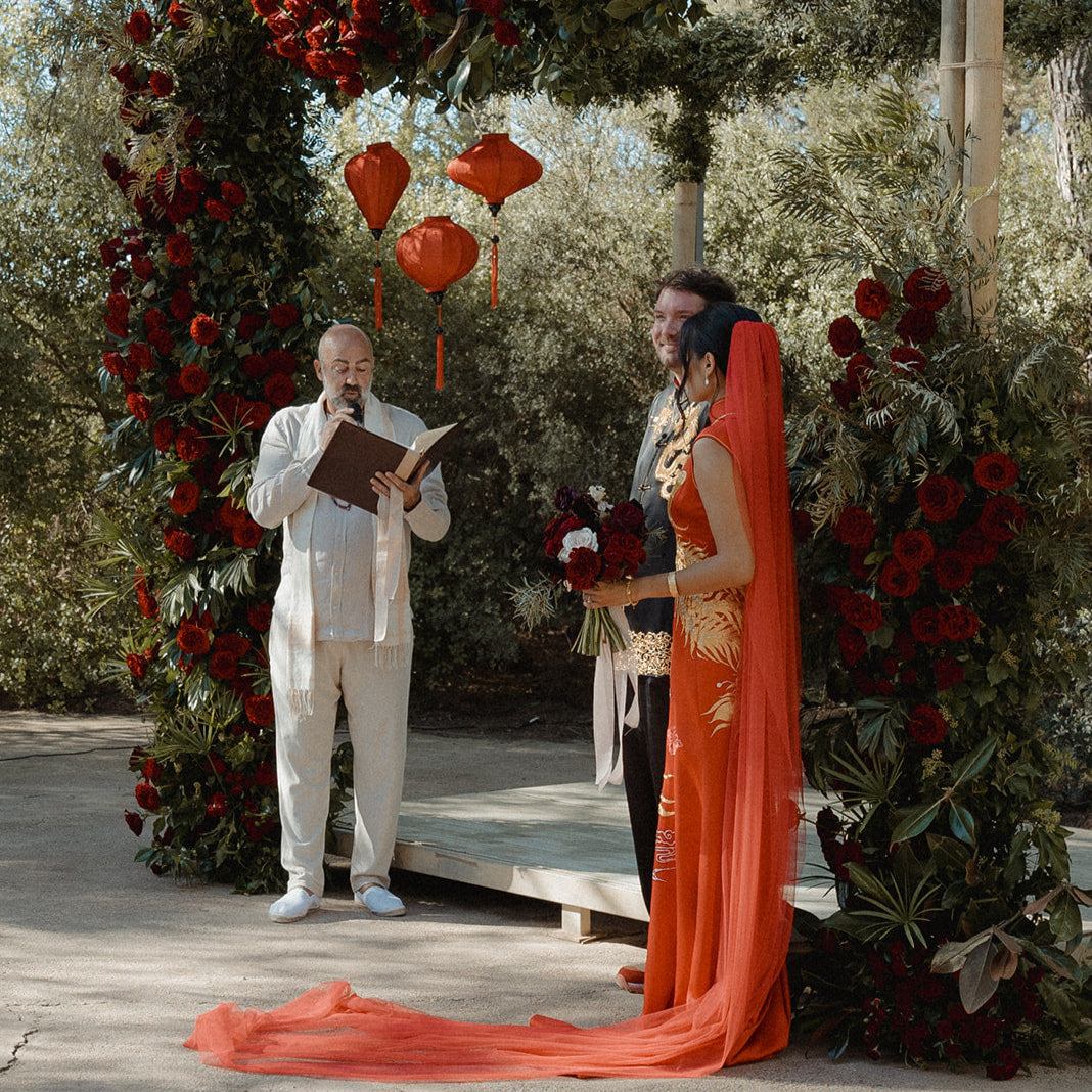 A side view of the red tulle chinese wedding veil, featuring red tulle to match a Qipao dress look.