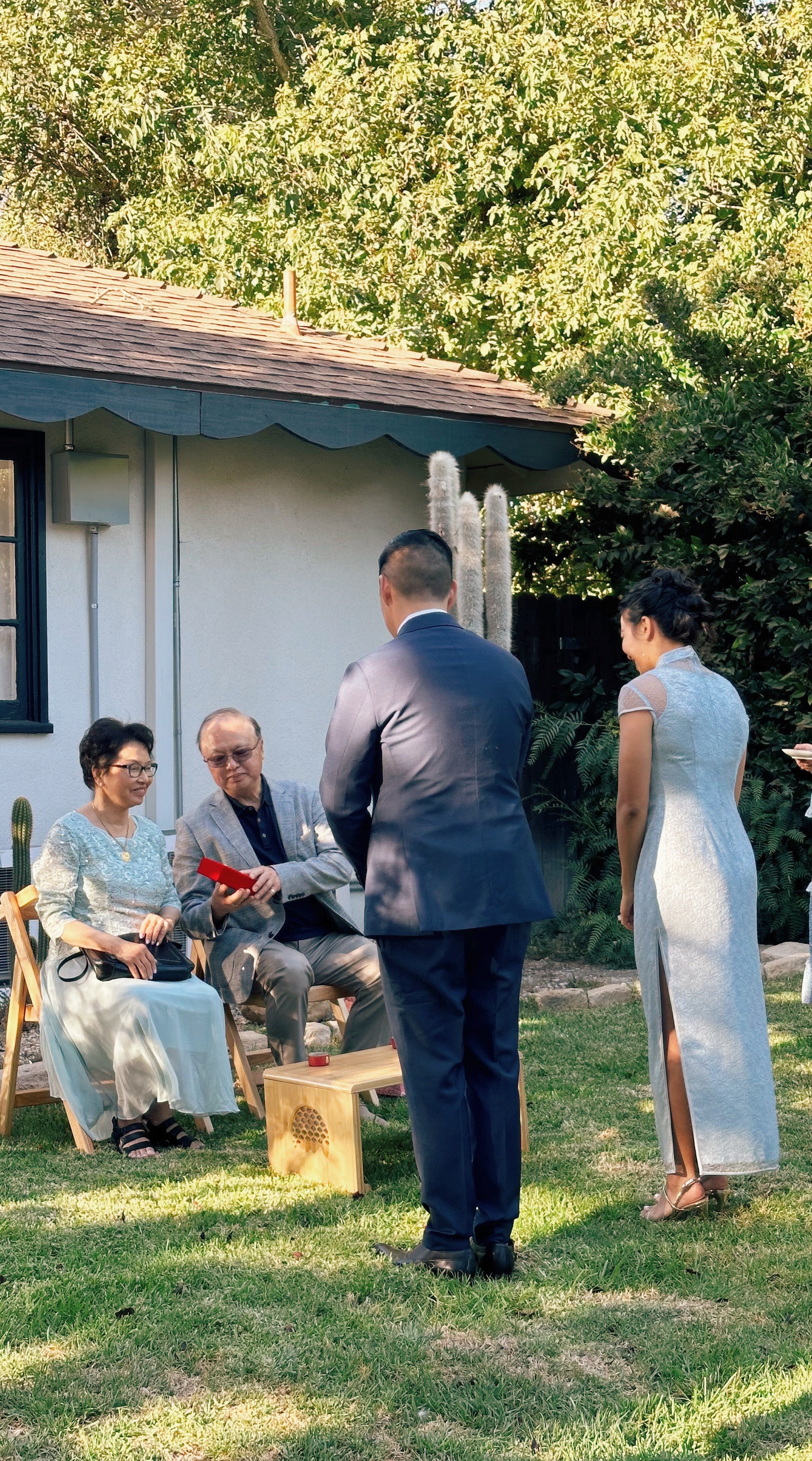 Back view of a modern sky blue Chantilly lace Cheongsam dress featuring silk lining, lace sleeves, and a see-through neckline, perfect for tea ceremonies and receptions.