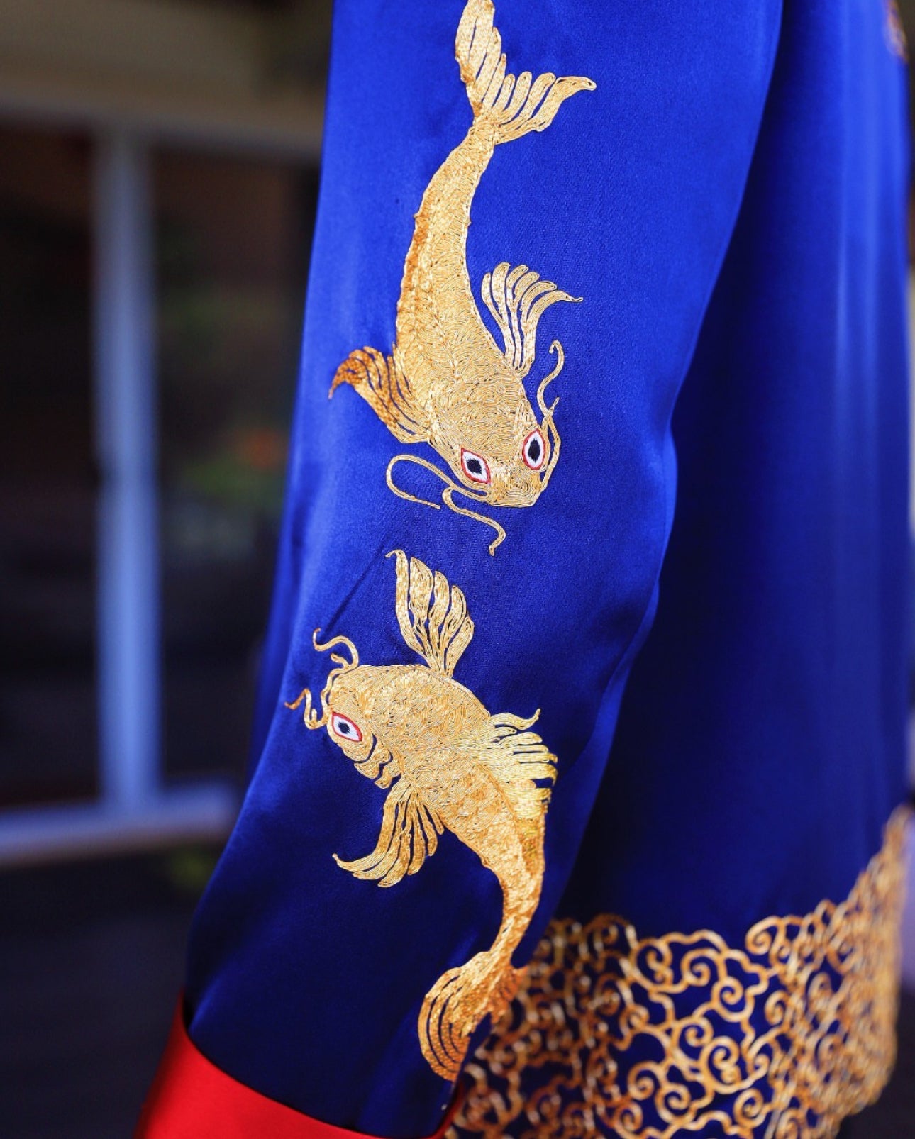 Details of hand-embroidered gold koi fishes on the sleeve of navy blue silk tang suit. 