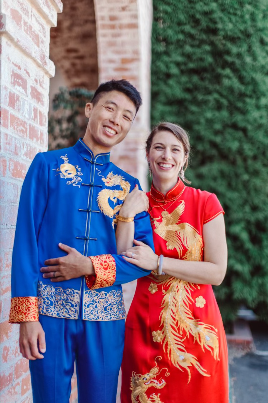 A couple wearing matching Tang suit and wedding Qipao at their multicultural wedding