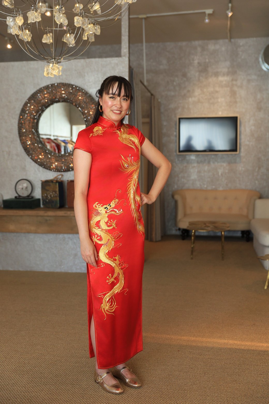 A client wearing a red Chinese Traditional Tea Ceremony dress with gold phoenix and dragon embroidery