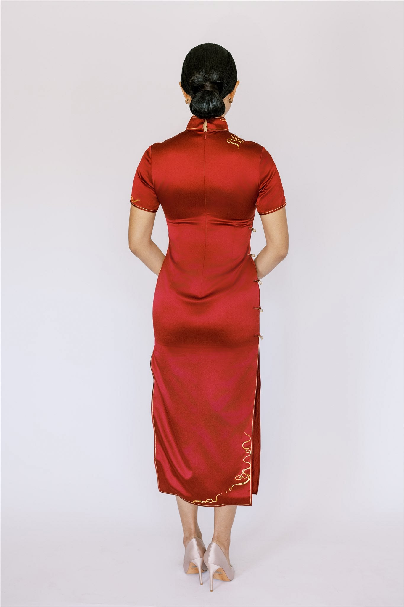 A woman wearing a red traditional cheongsam for wedding