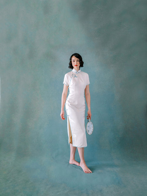 White silk Qipao with blue trim and side Pankou button closure