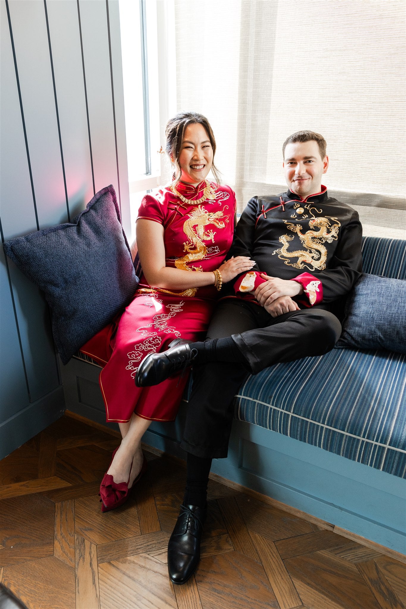 A couple smiling in their matching chinese suit and wedding qipao custom designed