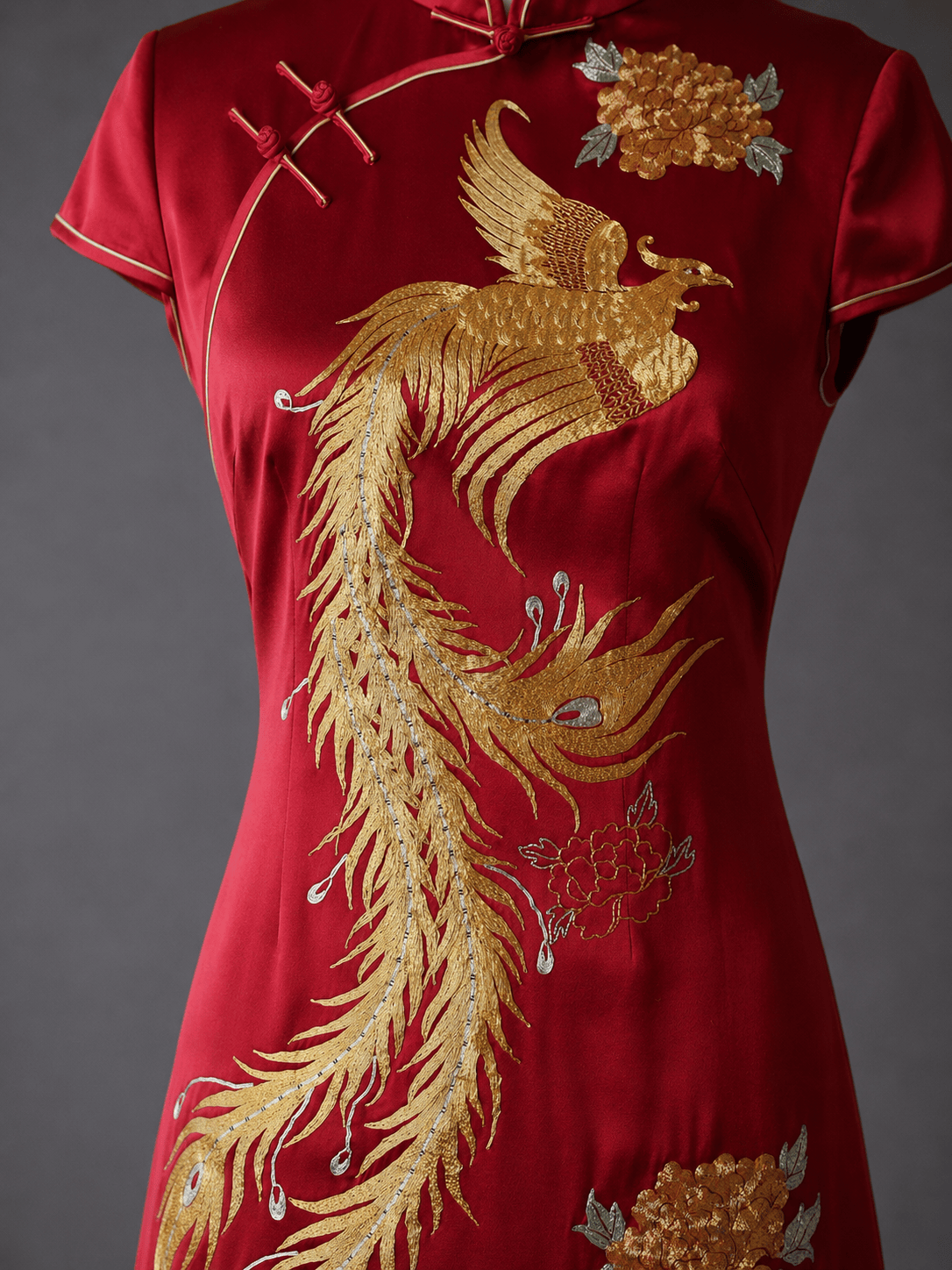 Hand embroidered phoenix tail feathers and gold peony detail in Panjin technique on wine red silk A-line Qipao — JINZA Oriental Couture, Los Angeles