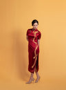 Front view of a wine red silk classic Qipao for wedding with gold phoenix embroidery, mandarin collar, and floral Pankou knot buttons.