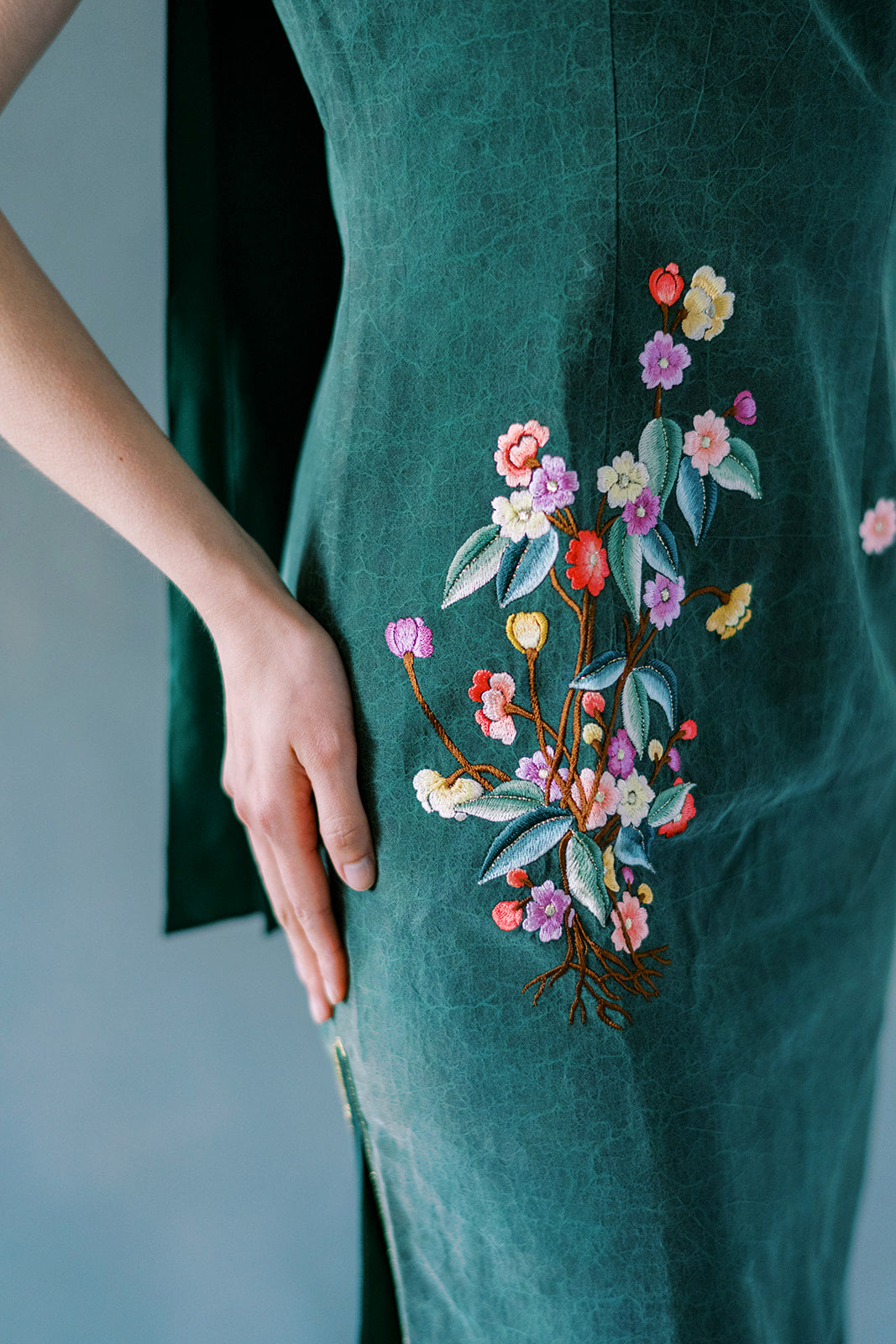 Close-up of custom flower embroidery on Xiang Yun silk Chinese dress